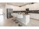 Modern kitchen boasts stainless steel appliances, white cabinetry, ample counter space, and a breakfast bar at 8986 Cabot Cliffs Dr, Davenport, FL 33896