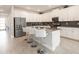 Modern kitchen boasts white cabinetry, stainless steel appliances, a gray tile backsplash, and a functional center island at 8986 Cabot Cliffs Dr, Davenport, FL 33896