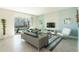 Bright living room with stylish sofas, a glass coffee table, and a view of the screened in pool area at 8986 Cabot Cliffs Dr, Davenport, FL 33896