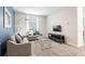Cozy living room featuring neutral tones, a modern sofa, and a flat-screen television at 8986 Cabot Cliffs Dr, Davenport, FL 33896