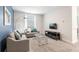 Bright living room with contemporary furnishings, large window, TV, and modern decor for comfortable living at 8986 Cabot Cliffs Dr, Davenport, FL 33896