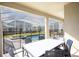 Outdoor dining set on the patio offers views of the screened-in pool and backyard at 8986 Cabot Cliffs Dr, Davenport, FL 33896