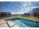 Relaxing enclosed pool area with clear blue water and ample space for leisure activities at 8986 Cabot Cliffs Dr, Davenport, FL 33896