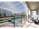 Private screened-in pool and spa with outdoor seating and view of the backyard and community at 8986 Cabot Cliffs Dr, Davenport, FL 33896