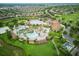 Wide aerial view of the Oasis Club House, pools, and surrounding residential area at 9061 Dogleg Dr, Davenport, FL 33896