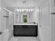 Well-lit bathroom features a double sink vanity with granite counters and a glass-enclosed shower at 9061 Dogleg Dr, Davenport, FL 33896