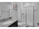 Clean bathroom featuring a sink with a granite countertop and a glass-enclosed shower at 9061 Dogleg Dr, Davenport, FL 33896