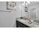 Bathroom with granite vanity, decorative towels, and neutral gray walls at 9061 Dogleg Dr, Davenport, FL 33896