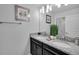 Bathroom featuring a double vanity with granite countertops and decorative plant at 9061 Dogleg Dr, Davenport, FL 33896