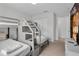 Bedroom featuring bunk beds, carpet, a white dresser and multiple doorways at 9061 Dogleg Dr, Davenport, FL 33896
