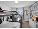 bedroom with gray bunk beds, cartoon wallpaper and a flat screen television at 9061 Dogleg Dr, Davenport, FL 33896