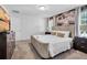 Comfortable bedroom featuring a plush bed, neutral colors, and a decorative accent wall at 9061 Dogleg Dr, Davenport, FL 33896