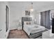 Comfortable bedroom features a gray padded headboard and a modern sphere chandelier at 9061 Dogleg Dr, Davenport, FL 33896