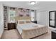 Relaxing bedroom features a comfortable bed with decorative pillows, dual nightstands, and a wallpapered accent wall at 9061 Dogleg Dr, Davenport, FL 33896