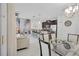 Open-concept living space featuring a modern kitchen, dining area, and comfortable seating area at 9061 Dogleg Dr, Davenport, FL 33896