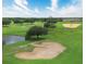 Aerial view of the golf course, showcasing a sand trap and pond at 9061 Dogleg Dr, Davenport, FL 33896