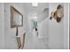 Bright hallway featuring sleek tile flooring, modern decor, and a view into the dining area at 9061 Dogleg Dr, Davenport, FL 33896