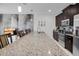 Spacious kitchen with granite counters, dark cabinets, and a stainless steel refrigerator at 9061 Dogleg Dr, Davenport, FL 33896