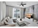 Relaxing living room featuring a gray sectional sofa, modern decor, and backyard views of the pool at 9061 Dogleg Dr, Davenport, FL 33896