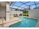Relaxing screened-in pool area with a grill, and refreshing water at 9061 Dogleg Dr, Davenport, FL 33896