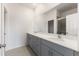 Bright bathroom featuring double vanity sinks, tile flooring, and a glass-enclosed shower at 9108 Wildlight, Wildwood, FL 34785