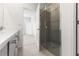 Bright bathroom with a glass-enclosed shower, a double vanity with ample counter space, and neutral tile at 9108 Wildlight, Wildwood, FL 34785