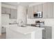 Modern kitchen featuring quartz countertops, stainless steel appliances, a center island and ample storage at 9108 Wildlight, Wildwood, FL 34785
