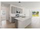 Modern kitchen featuring quartz countertops, stainless steel appliances, a center island and ample cabinet space at 9108 Wildlight, Wildwood, FL 34785