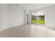 Bright living room featuring tile flooring and a sliding glass door leading to the backyard at 9108 Wildlight, Wildwood, FL 34785