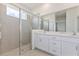 Bright bathroom featuring a walk-in shower, double sink vanity, and modern fixtures at 9113 Wildlight, Wildwood, FL 34785