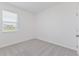 A compact bedroom with a neutral palette, natural light, and plush carpet flooring at 9113 Wildlight, Wildwood, FL 34785