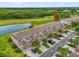 Aerial view of townhomes next to a golf course and lake at 9435 Myrtle Creek Ln # 308, Orlando, FL 32832