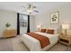 Bright bedroom featuring a ceiling fan and large window with curtains at 9435 Myrtle Creek Ln # 308, Orlando, FL 32832