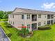 A view of the home from the rear with screened-in patio and well-maintained lawn at 9435 Myrtle Creek Ln # 308, Orlando, FL 32832