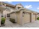 Attached garage featuring an automatic door and well-manicured bushes at 9435 Myrtle Creek Ln # 308, Orlando, FL 32832