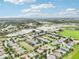 A scenic aerial shot of homes in the community, many with solar panels, surrounded by natural Florida landscape at 106 Mist Flower Ln, Groveland, FL 34736