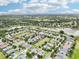 A high aerial view of a neighborhood with ponds and green spaces, showcasing community layout and solar panels at 106 Mist Flower Ln, Groveland, FL 34736