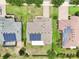 Overhead view highlighting rooftop solar panels, backyard landscaping, and neighborhood layout at 106 Mist Flower Ln, Groveland, FL 34736