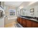 Bathroom featuring dual sinks, vanity, a large soaking tub, and a separate walk-in shower at 106 Mist Flower Ln, Groveland, FL 34736