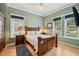 Comfortable bedroom with wood furniture and plenty of natural light at 106 Mist Flower Ln, Groveland, FL 34736