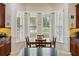Bright breakfast nook features a bay window with views of the landscaped yard at 106 Mist Flower Ln, Groveland, FL 34736
