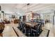 Spacious dining area with tile floors, a large dining table, and an open layout to the kitchen at 106 Mist Flower Ln, Groveland, FL 34736