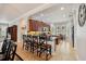 Bright and open kitchen with an island, breakfast bar, and ample cabinet space at 106 Mist Flower Ln, Groveland, FL 34736