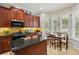 Well-equipped kitchen with modern appliances, granite countertops, and a cozy breakfast nook at 106 Mist Flower Ln, Groveland, FL 34736