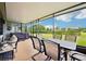 Covered lanai featuring an outdoor dining area with seating and hot tub, perfect for entertaining at 106 Mist Flower Ln, Groveland, FL 34736