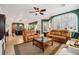 Open-concept living room with tile floors, plush seating, and access to the dining area at 106 Mist Flower Ln, Groveland, FL 34736