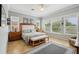 Spacious main bedroom with tile floors, ceiling fan, and multiple windows at 106 Mist Flower Ln, Groveland, FL 34736