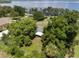 An aerial view of a property surrounded by mature trees at 12130 Lakeshore Dr, Clermont, FL 34711