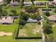 Spacious property with well-manicured lawn, mature trees, and a long driveway and outbuilding at 12130 Lakeshore Dr, Clermont, FL 34711