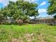 View of a large backyard with a screened-in porch at 12130 Lakeshore Dr, Clermont, FL 34711